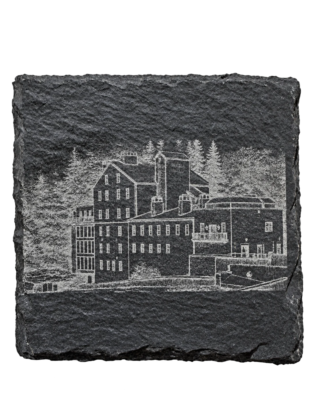 Square natural slate coaster etched with a mill and lodge building among trees.